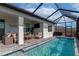 Enclosed pool and patio featuring a seating area, outdoor television, and built-in grill at 2930 61St E Dr, Ellenton, FL 34222