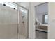 Modern tiled shower with glass door, a built-in niche, and a glimpse into the serene bedroom at 2930 61St E Dr, Ellenton, FL 34222