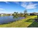 Scenic backyard view of the lake and manicured lawn on a sunny day at 3325 Azurite Way, Bradenton, FL 34211