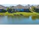 View of a backyard that includes pond and screened in patio at 3325 Azurite Way, Bradenton, FL 34211