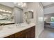 Bathroom featuring dark wood cabinets, a white countertop, and a view into the bedroom at 3325 Azurite Way, Bradenton, FL 34211