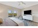 Comfortable bedroom with a window view, a neutral color scheme, and a dresser with modern accents at 3325 Azurite Way, Bradenton, FL 34211