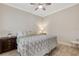 Neutral bedroom featuring tile floors, a ceiling fan, and a comfortable bed with decorative pillows at 3325 Azurite Way, Bradenton, FL 34211