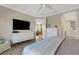 A well-lit main bedroom with white dressers and a view to the living area at 3325 Azurite Way, Bradenton, FL 34211