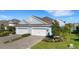 Beautiful two-story home with a three-car garage, complemented by a well-manicured lawn and lush landscaping at 3325 Azurite Way, Bradenton, FL 34211