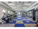 Well-equipped gym featuring treadmills, weight machines, and a blue and gray checkered floor design at 3325 Azurite Way, Bradenton, FL 34211