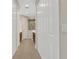 Bright hallway featuring tile floors, white doors, and access to the bathroom with modern fixtures at 3325 Azurite Way, Bradenton, FL 34211