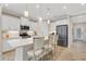Modern kitchen with stainless steel appliances, white cabinets and a quartz countertop island at 3325 Azurite Way, Bradenton, FL 34211