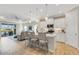Bright kitchen featuring white cabinets, stainless appliances, and bar seating overlooking the living area at 3325 Azurite Way, Bradenton, FL 34211