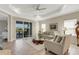 Cozy living room with tile floors, comfortable seating, and sliding glass doors leading to an outdoor patio area at 3325 Azurite Way, Bradenton, FL 34211