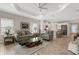 Open concept living room with wood-look tile flooring and view into the kitchen at 3325 Azurite Way, Bradenton, FL 34211
