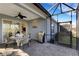 Screened patio featuring a round glass table, grill, and view to the backyard at 3325 Azurite Way, Bradenton, FL 34211
