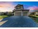 Two-story home with a three-car garage and a paved driveway at 4852 Coastal Days Ln, Bradenton, FL 34211