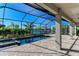 Screened-in pool area with lake views, a jacuzzi, and a brick-paver deck at 4852 Coastal Days Ln, Bradenton, FL 34211