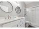 Modern bathroom with double sinks, white subway tile shower, and sleek fixtures at 7117 Queen Palm Cir, Sarasota, FL 34243