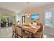 Formal dining room with decorative rug, modern chandelier, and sliding door access to the outdoor space at 735 Foggy Morn Ln, Bradenton, FL 34212