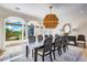 Elegant dining room with views of the landscaped grounds and a statement chandelier at 1023 Tocobaga Ln, Sarasota, FL 34236