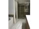 Elegant bathroom with a glass-enclosed shower, soaking tub, and neutral tile flooring at 15079 Wichita Rd, Port Charlotte, FL 33981