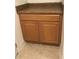 A small cabinet with wood doors and a brown countertop sits on top of tiled flooring at 15079 Wichita Rd, Port Charlotte, FL 33981