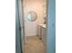 Tiled laundry room featuring new washer and dryer with shelving and a mirror at 15079 Wichita Rd, Port Charlotte, FL 33981