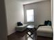 Bright living room features a hardwood floor, window, and comfortable seating at 15079 Wichita Rd, Port Charlotte, FL 33981