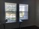 Sunlit office space with bright windows offering a view of the outdoors and a sleek glass desk at 15079 Wichita Rd, Port Charlotte, FL 33981