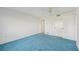 The main bedroom with blue carpeting, a ceiling fan and white walls at 250 Santa Maria St # 120, Venice, FL 34285