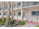 The lower floor exterior showing a unit with neutral paint and dark balcony railings at 250 Santa Maria St # 120, Venice, FL 34285