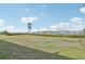 Picturesque harbor view featuring a grassy lawn, palm tree, and recreational boats at 250 Santa Maria St # 120, Venice, FL 34285