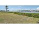 Beautiful waterfront view with lush green grass and a bench overlooking the harbor at 250 Santa Maria St # 120, Venice, FL 34285