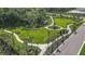 Aerial view of a well manicured community park with walking paths and lush landscaping at 3016 Formia Ct, Bradenton, FL 34211