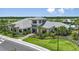 Grand home with a manicured lawn, mature trees, and professional landscaping at 3016 Formia Ct, Bradenton, FL 34211