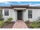 Charming single-Gathering home featuring a black front door, decorative tiled roof, and a landscaped walkway at 3016 Formia Ct, Bradenton, FL 34211