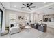 Bright living room with a tray ceiling, neutral-toned furniture, and an open layout to the kitchen at 3016 Formia Ct, Bradenton, FL 34211