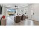 Spacious living room with a screened-in patio, neutral furniture, and plenty of natural light at 3016 Formia Ct, Bradenton, FL 34211