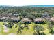 An aerial view of a community, showcasing lush landscaping, red tile roofs, and the ocean at 3500 El Conquistador Pkwy # 119, Bradenton, FL 34210