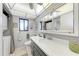 Full bathroom featuring an extended vanity, and in-unit washer and dryer at 3500 El Conquistador Pkwy # 119, Bradenton, FL 34210