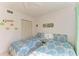 Bright bedroom with two twin beds, ceiling fan, and whimsical wall decorations at 3500 El Conquistador Pkwy # 119, Bradenton, FL 34210