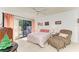 Bright bedroom with a ceiling fan, comfortable seating area, and a sliding door to the outside at 3500 El Conquistador Pkwy # 119, Bradenton, FL 34210