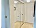 Hallway view of closet with mirrored sliding doors providing both functionality and aesthetic appeal to the space at 3500 El Conquistador Pkwy # 119, Bradenton, FL 34210