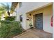 Inviting entrance with decorative accents, a storm door and lush landscaping at 3500 El Conquistador Pkwy # 119, Bradenton, FL 34210