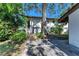 Charming two-story building with lush landscaping, mature trees, and a tile roof at 3500 El Conquistador Pkwy # 119, Bradenton, FL 34210