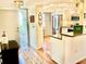 Open foyer leading to a modern kitchen with stainless steel appliances and wood floors at 3500 El Conquistador Pkwy # 119, Bradenton, FL 34210