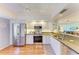 Bright kitchen showcases stainless appliances, ample cabinets, and wood flooring at 3500 El Conquistador Pkwy # 119, Bradenton, FL 34210