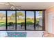 Enclosed lanai showcasing sliding glass doors to a manicured lawn at 3500 El Conquistador Pkwy # 119, Bradenton, FL 34210