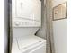 White stacked washer and dryer unit with laundry rules sign hanging on the wall at 3500 El Conquistador Pkwy # 119, Bradenton, FL 34210