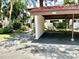 Assigned covered parking spot. Unit number clearly displayed, surrounded by landscaping and walkway to unit at 3500 El Conquistador Pkwy # 119, Bradenton, FL 34210