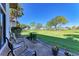 Patio area overlooking a lush green lawn with comfortable seating and potted plants at 3500 El Conquistador Pkwy # 119, Bradenton, FL 34210