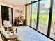 Bright sunroom with large windows offering panoramic views of the golf course at 3500 El Conquistador Pkwy # 119, Bradenton, FL 34210