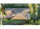 Aerial view of a house with a complex roofline, surrounded by a lush green lawn and mature trees at 5341 Greenbrook Dr, Sarasota, FL 34238